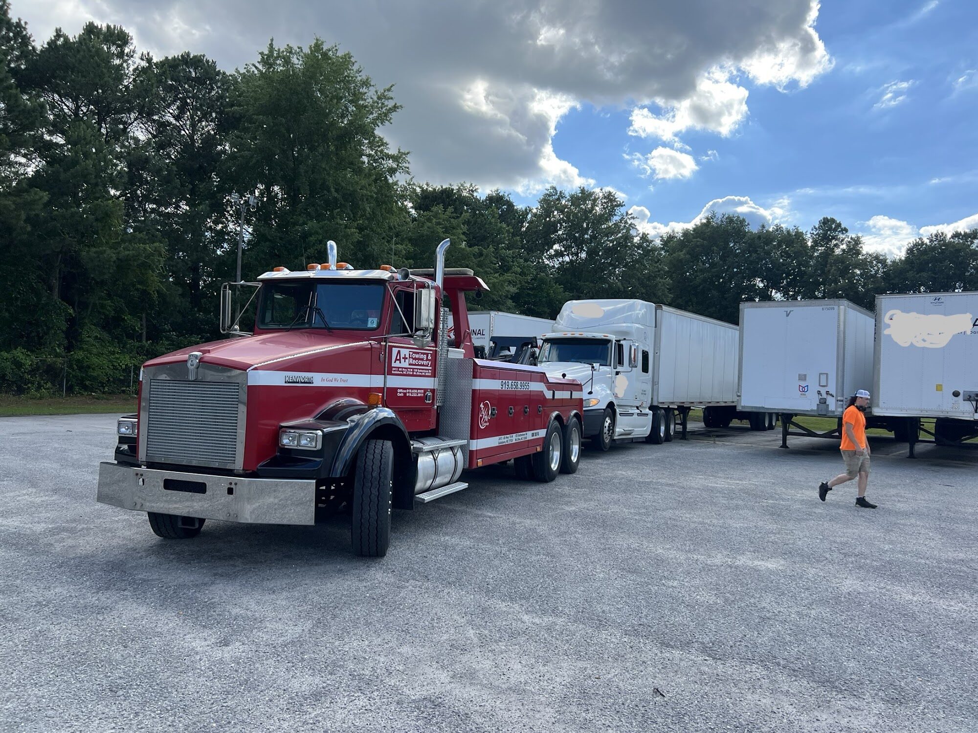 Heavy-duty A Plus tow truck recovering a tractor trailer
